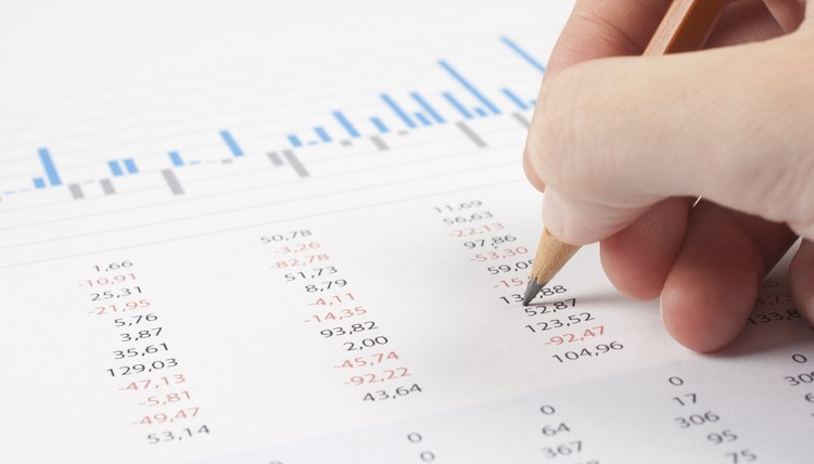 Close-up of economist going over numbers.