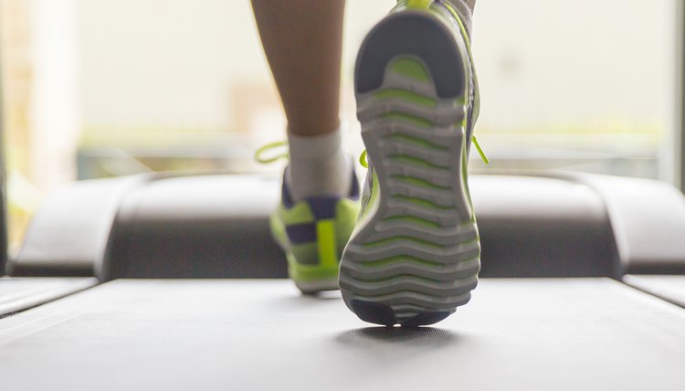 Close up woman running on treadmill