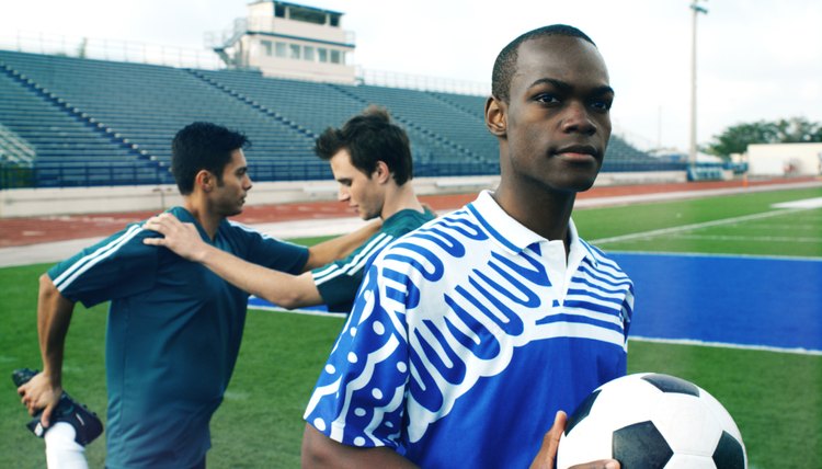 three football players on a football field