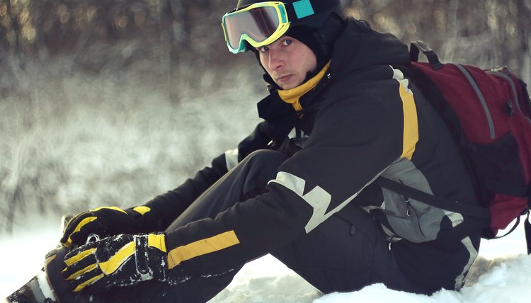 Man gets snowboard and looks at the camera