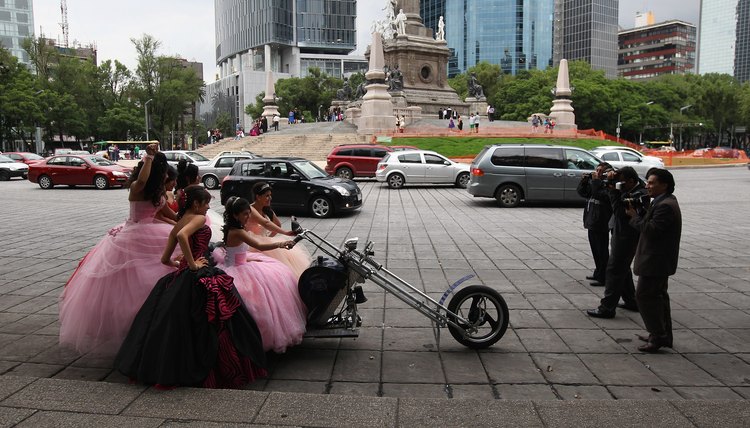 Quinceanera girls pose on a chopper in Mexico City