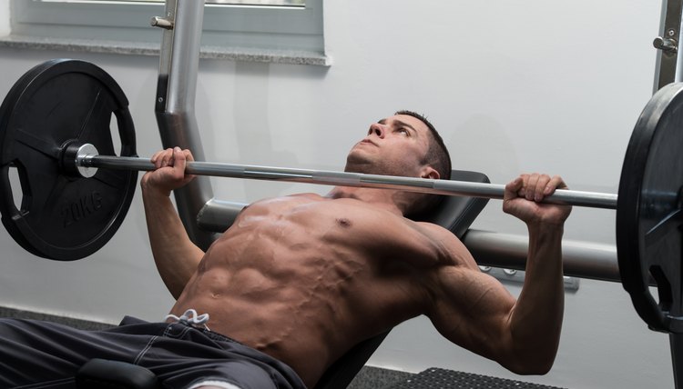 Young Man Doing Bench Press Exercise For Chest