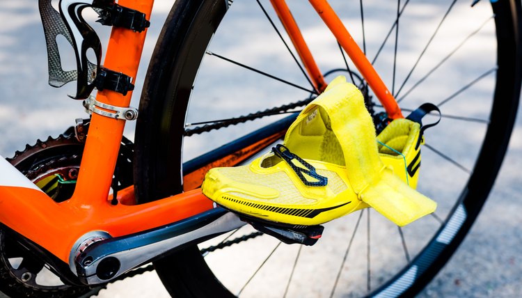 Wheel of the bicycle,orange frame,yellow cycling shoes
