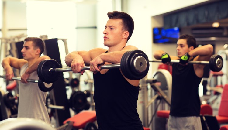 group of men with barbells in gym