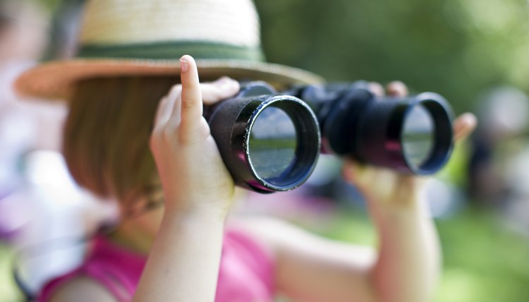 Girl looking through binoculars