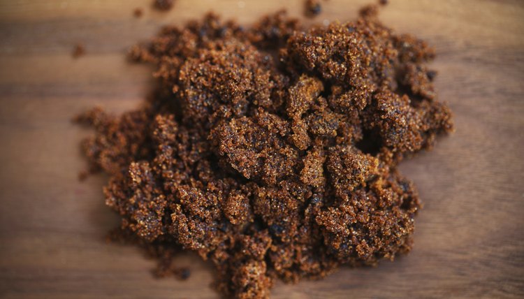 Brown sugar molasses on a wood table.