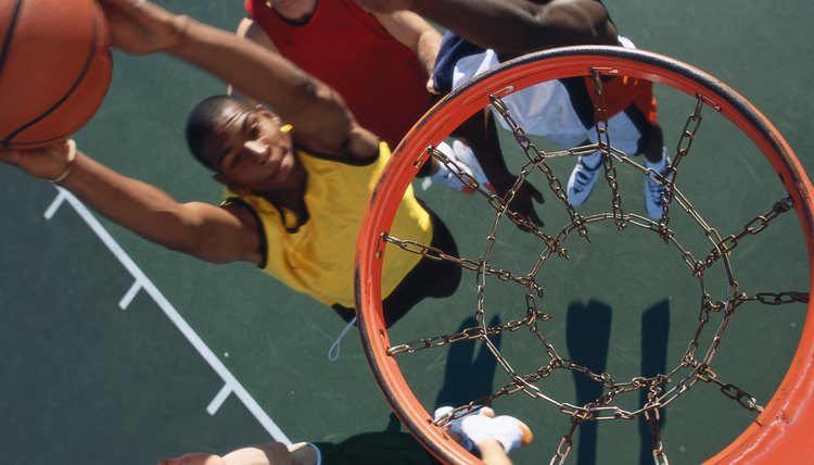 high angle view of a basketball player slam dunking a basketball