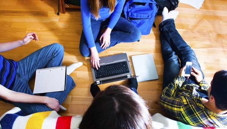 A group of students studying on the floor.