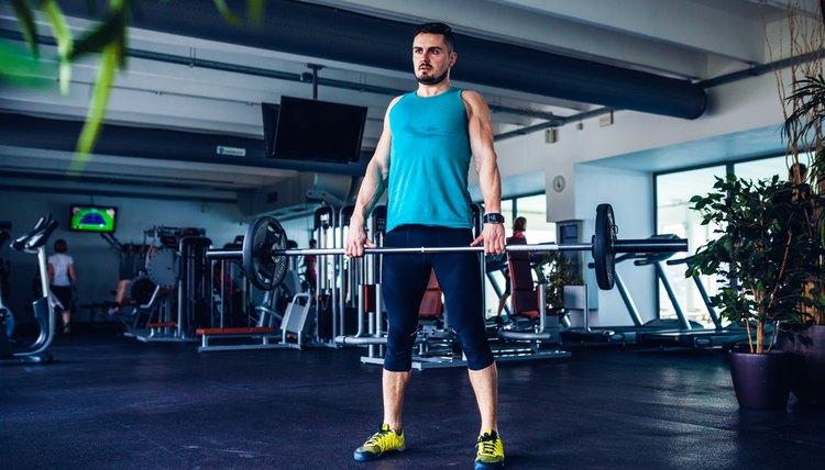 Crossfit instructor at the gym doing Deadlift exercises