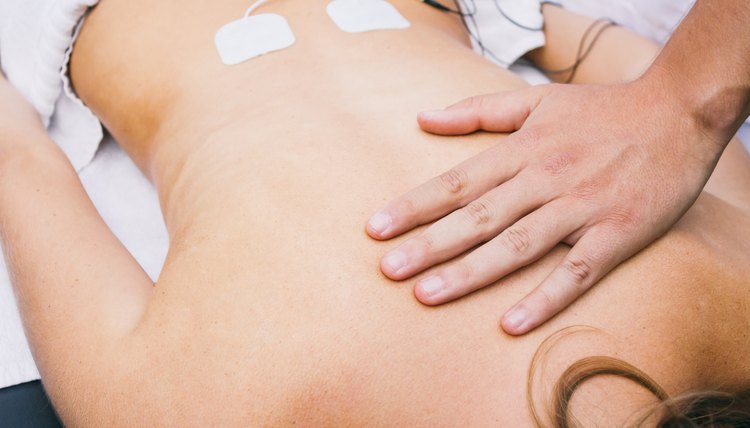 Hand and electrodes on a patient's lumbar