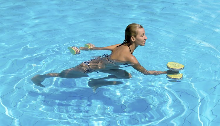 Aqua aerobic, woman in water with dumbbells