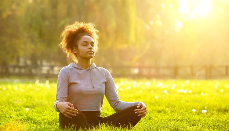 African american woman meditating in nature