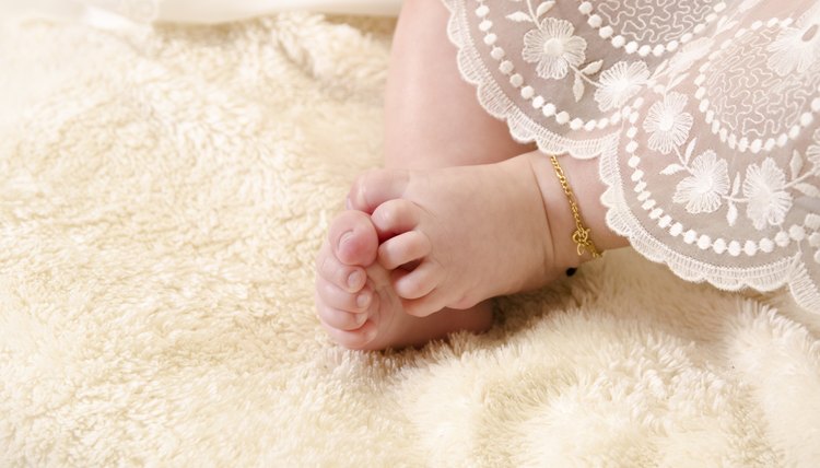 Baptism clothing covering baby's legs.