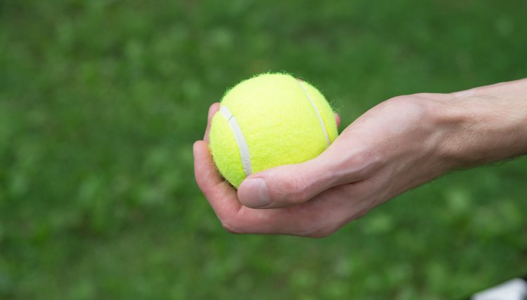 tennis ball in man hand close up
