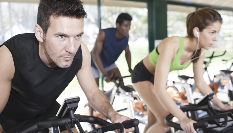 Three Friends Are In A Spinning Class At Gym