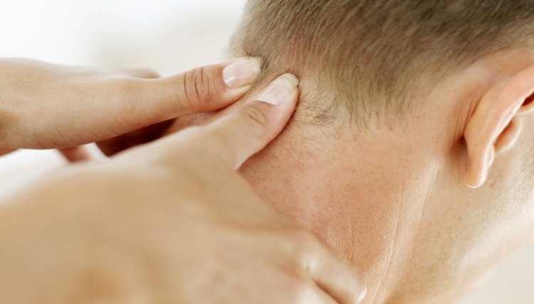 close up of a masseur massaging a man's neck