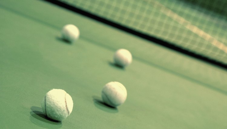 Four tennis balls on a tennis court