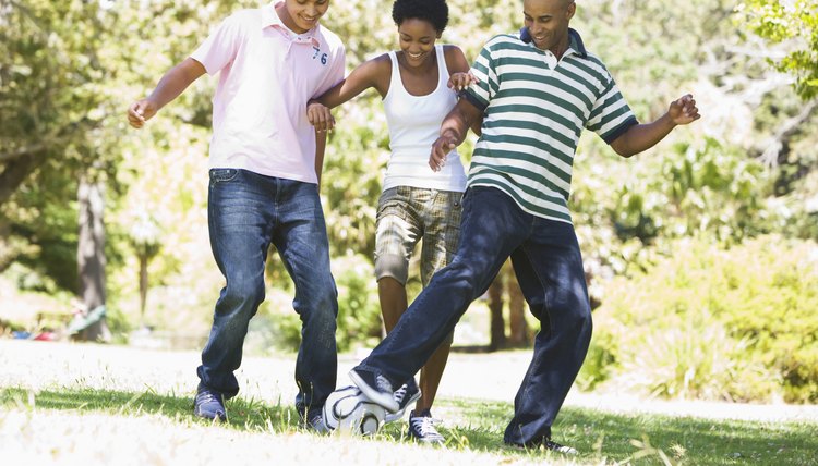 Family kicking ball