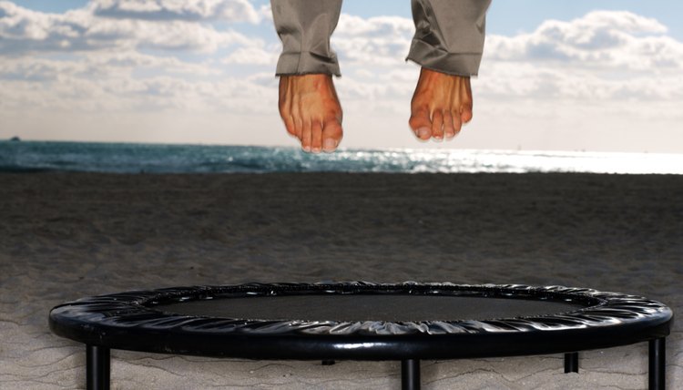 a pair of legs jumping on a trampoline