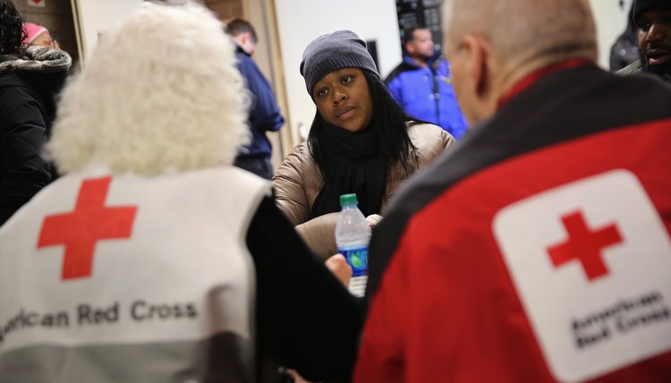 American Red Cross volunteers talking to woman