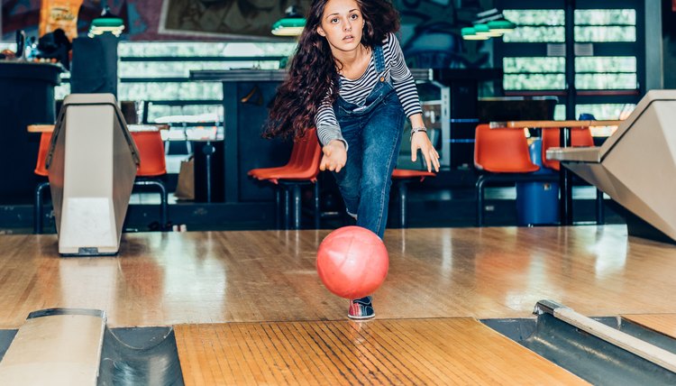 young girl plays bowling