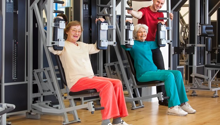 Smiling Elderly Women at the Gym with Instructor.