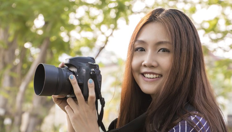 High school student holding DSLR camera