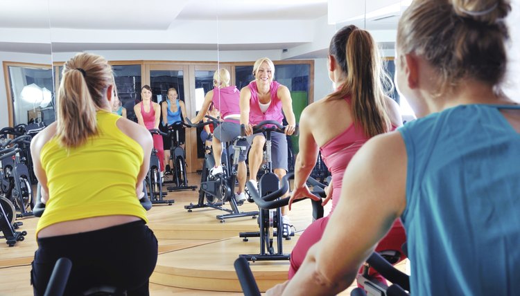 Beautiful women doing exercise in a spinning class at gym