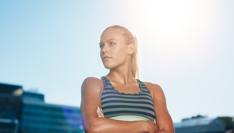 Muscular female athlete in outdoors stadium