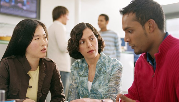 Man complaining to two female co-workers.