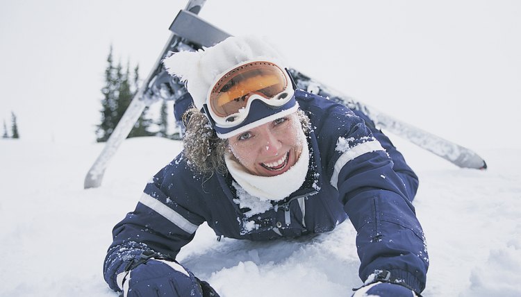 Portrait of a Smiling Woman Falling Down on a Ski Slope