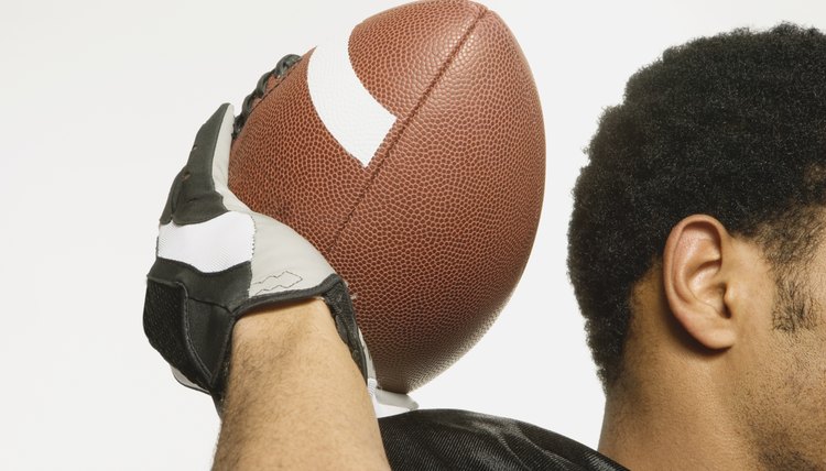 African American man holding football