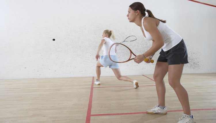 Two Young Women Playing Squash