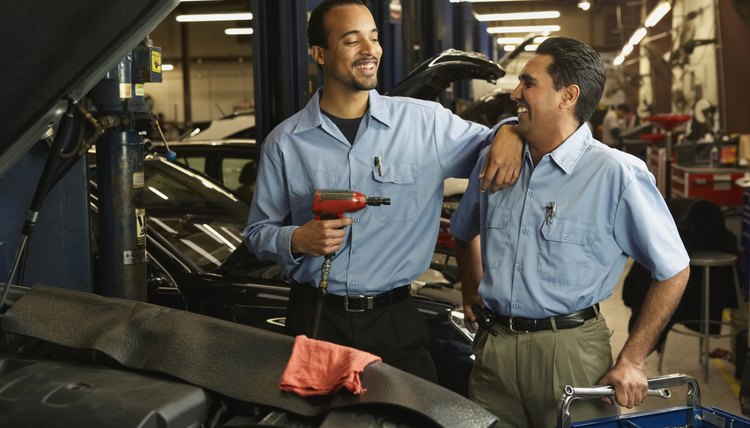 Car repair employees in garage.