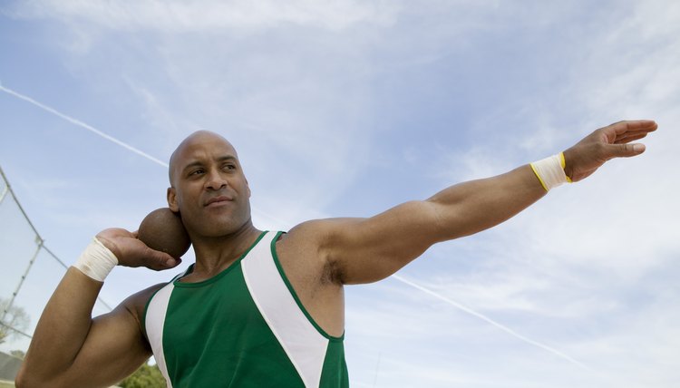 Male shot putter holding shot