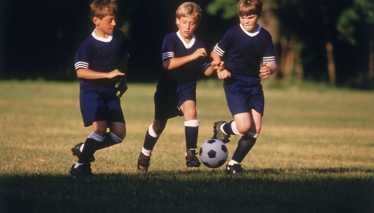 Boys kicking a soccer ball