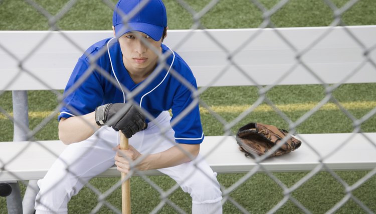 Serious baseball player sitting on bench