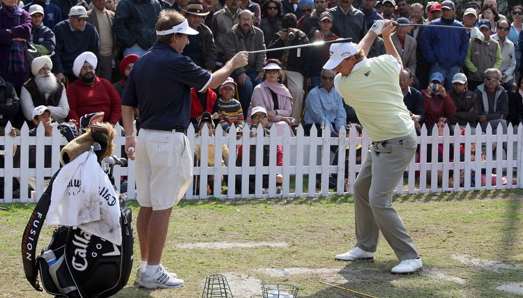 Even Ernie Els uses his caddie on the driving range in a drill that reminds him to keep his head still through the swing.