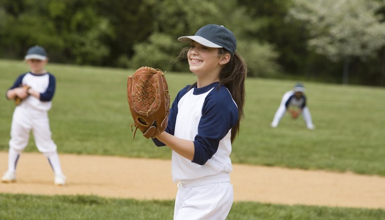 Girl pitching in little league softball game