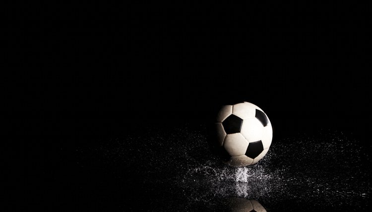 Soccer ball on black reflective surface