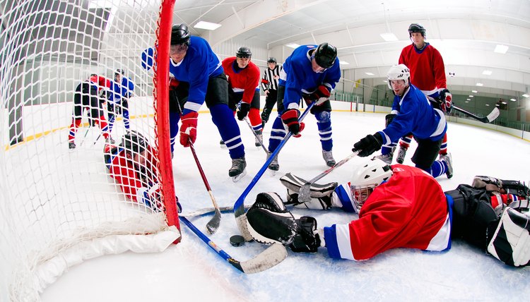 Hockey players and goalie