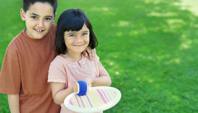 high angle view of a brother and his sister standing in a park