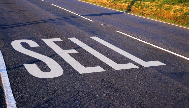 view of a sign painted on the surface of the road saying sell