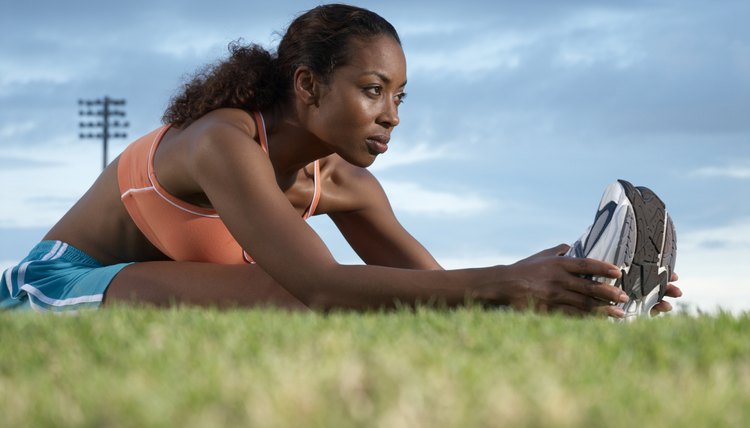 Young woman performing warming up exercises