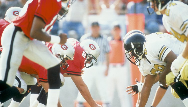 Football players at scrimmage line during game