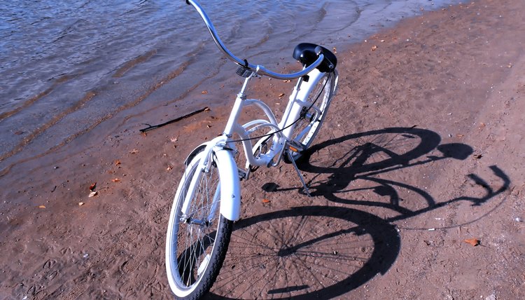 white retro bike on a sand beach