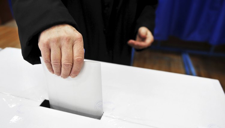 Man dropping vote into ballot box