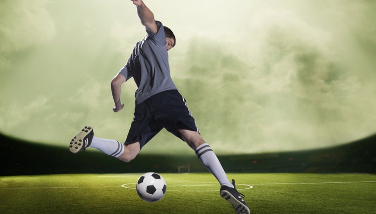 Soccer player kicking the ball in a stadium, green sky with clouds