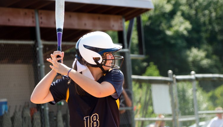 Teen girl playing softball in organized game