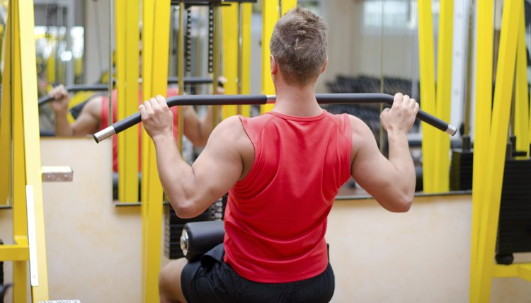 Handsome young man working out on gym equipment